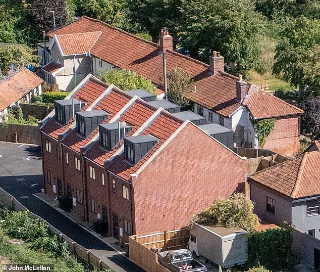 101733861-15057429-The_use_of_this_row_of_houses_front_left_in_a_small_village_in_S-a-12_17568127051.jpeg